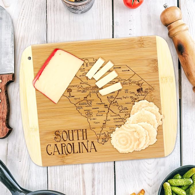 Totally Bamboo A Slice of Life South Carolina Engraved Map Cutting Board | 11” x 8.75” charcuterie board with engraved state map artwork. Smooth reverse side for food prep. Hang tie for wall display.