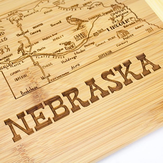 Totally Bamboo A Slice of Life Nebraska Engraved Map Cutting Board | 11” x 8.75” charcuterie board with engraved state map artwork. Smooth reverse side for food prep. Hang tie for wall display.