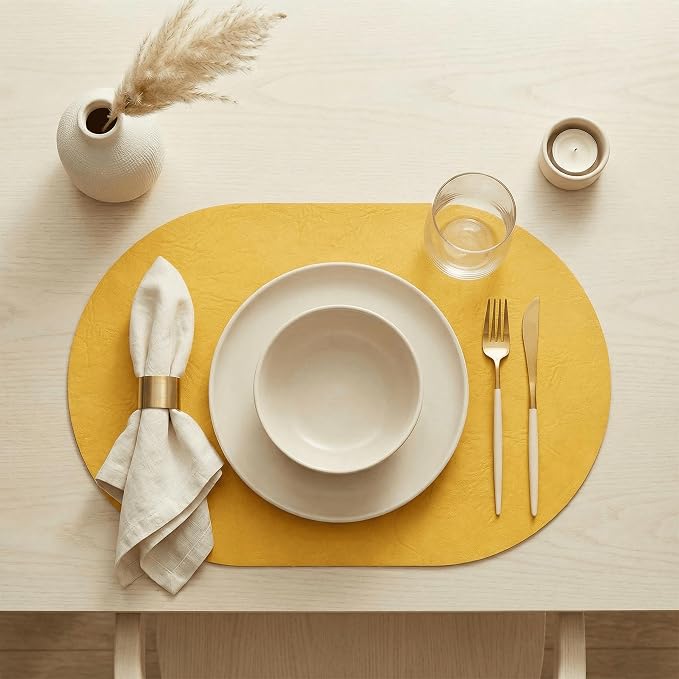 Artoid Mode Yellow Faux Leather Oval Placemats Set of 4, 12 x 18 Inch Waterproof Wipeable Heat Resistant Vinyl Place Mats, Reversible Table Mats for Kitchen Dining Decor