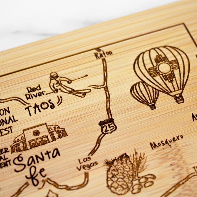 Totally Bamboo A Slice of Life New Mexico Engraved Map Cutting Board | 11” x 8.75” charcuterie board with engraved state map artwork. Smooth reverse side for food prep. Hang tie for wall display.