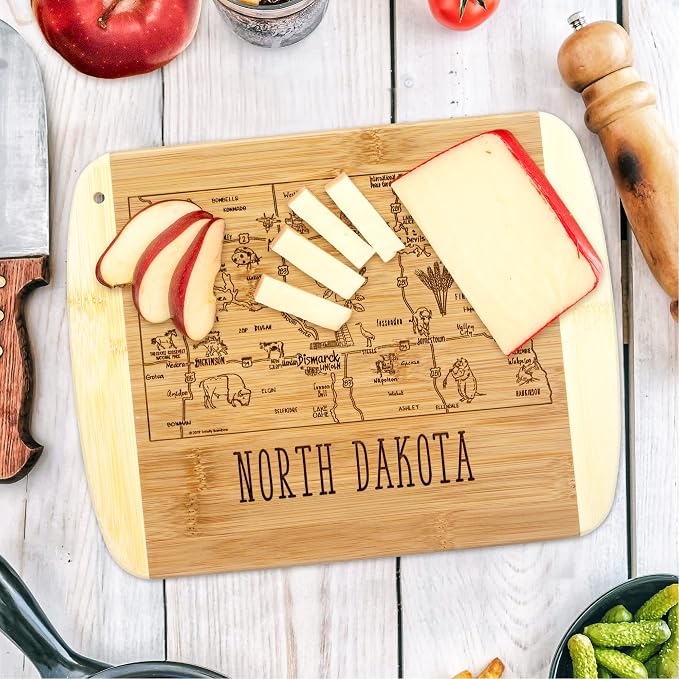 Totally Bamboo A Slice of Life North Dakota Engraved Map Cutting Board | 11” x 8.75” charcuterie board with engraved state map artwork. Smooth reverse side for food prep. Hang tie for wall display.