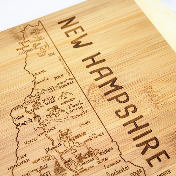 Totally Bamboo A Slice of Life New Hampshire Engraved Map Cutting Board | 11” x 8.75” charcuterie board with engraved state map artwork. Smooth reverse side for food prep. Hang tie for wall display.