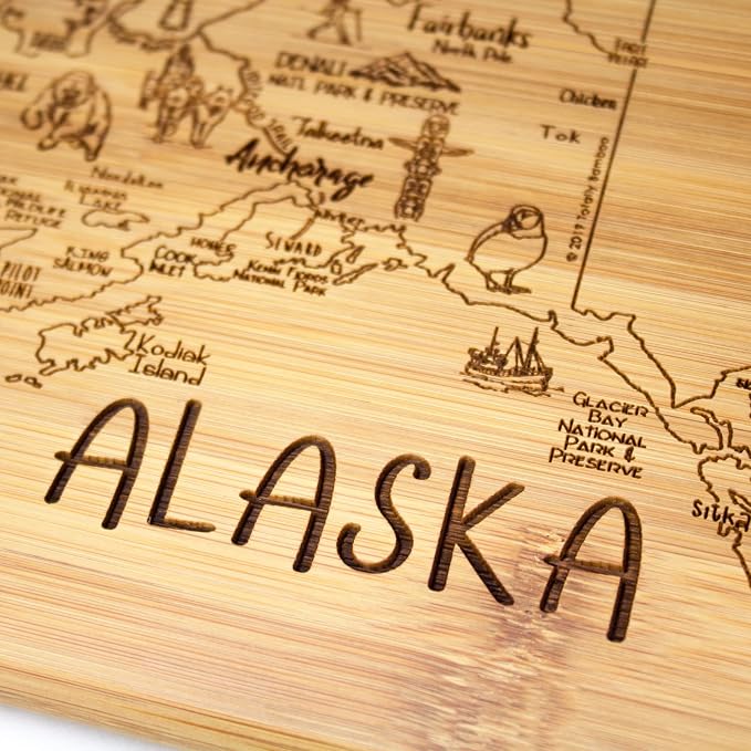 Totally Bamboo A Slice of Life Alaska Engraved Map Cutting Board | 11” x 8.75” charcuterie board with engraved state map artwork. Smooth reverse side for food prep. Hang tie for wall display.