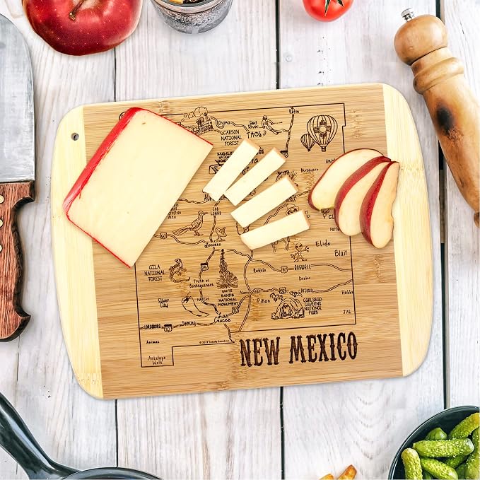 Totally Bamboo A Slice of Life New Mexico Engraved Map Cutting Board | 11” x 8.75” charcuterie board with engraved state map artwork. Smooth reverse side for food prep. Hang tie for wall display.
