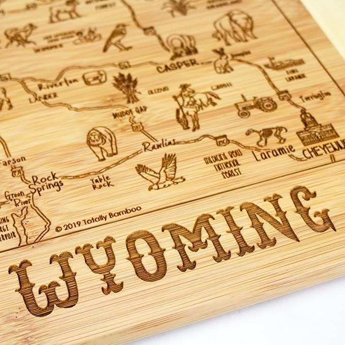 Totally Bamboo A Slice of Life Wyoming Engraved Map Cutting Board | 11” x 8.75” charcuterie board with engraved state map artwork. Smooth reverse side for food prep. Hang tie for wall display.