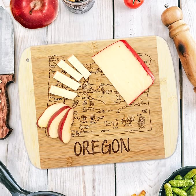 Totally Bamboo A Slice of Life Oregon Engraved Map Cutting Board | 11” x 8.75” charcuterie board with engraved state map artwork. Smooth reverse side for food prep. Hang tie for wall display.