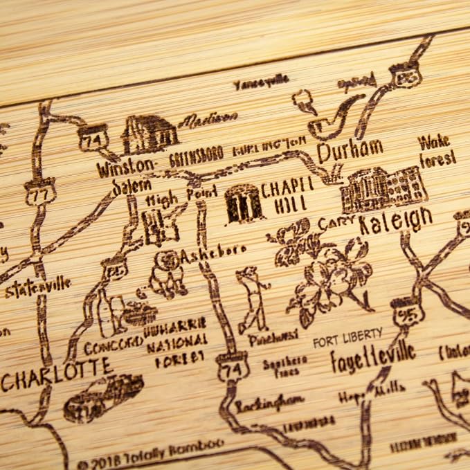 Totally Bamboo A Slice of Life North Carolina Engraved Map Cutting Board | 11” x 8.75” charcuterie board with engraved state map artwork. Smooth reverse side for food prep. Hang tie for wall display.
