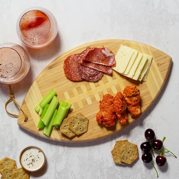 Totally Bamboo Football Shaped Cutting Board and Charcuterie Board | Football serving board for game day watch parties and tailgating. Smooth reverse side for prep. Hangs as decor between uses.