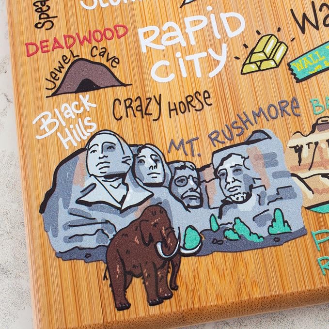 Totally Bamboo South Dakota State Shaped Cutting Board, Art by Fish Kiss | State charcuterie board with colorful hand-drawn map artwork. Smooth reverse side for food prep. Hang tie for wall display.