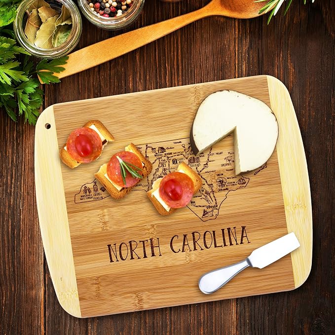 Totally Bamboo A Slice of Life North Carolina Engraved Map Cutting Board | 11” x 8.75” charcuterie board with engraved state map artwork. Smooth reverse side for food prep. Hang tie for wall display.