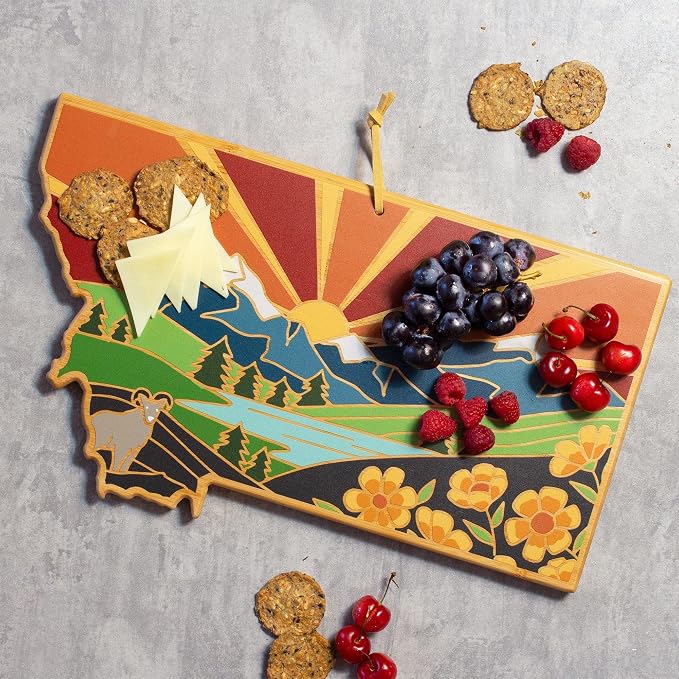 Totally Bamboo Montana State Shaped Cutting Board, Summer Stokes Art | State charcuterie board with colorful hand-drawn landscape art. Smooth reverse side for food prep. Hang tie for wall display.
