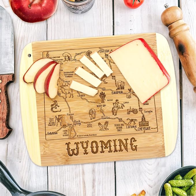 Totally Bamboo A Slice of Life Wyoming Engraved Map Cutting Board | 11” x 8.75” charcuterie board with engraved state map artwork. Smooth reverse side for food prep. Hang tie for wall display.
