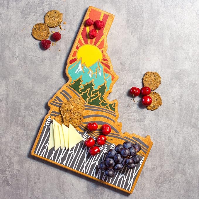 Totally Bamboo Idaho State Shaped Cutting Board, Summer Stokes Art | State charcuterie board with colorful hand-drawn landscape art. Smooth reverse side for food prep. Hang tie for wall display.