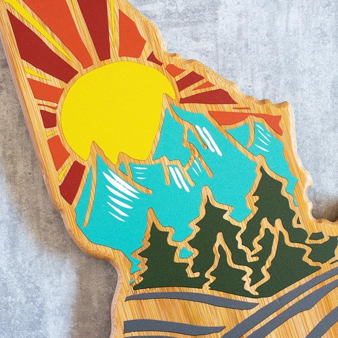 Totally Bamboo Idaho State Shaped Cutting Board, Summer Stokes Art | State charcuterie board with colorful hand-drawn landscape art. Smooth reverse side for food prep. Hang tie for wall display.