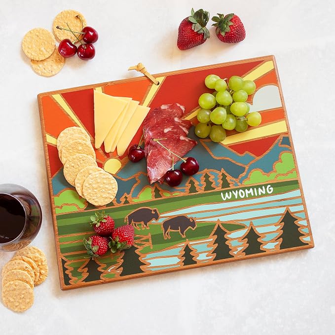 Totally Bamboo Wyoming State Shaped Cutting Board, Summer Stokes Art | State charcuterie board with colorful hand-drawn landscape art. Smooth reverse side for food prep. Hang tie for wall display.
