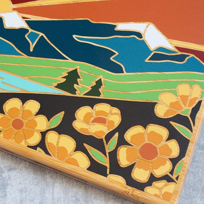 Totally Bamboo Montana State Shaped Cutting Board, Summer Stokes Art | State charcuterie board with colorful hand-drawn landscape art. Smooth reverse side for food prep. Hang tie for wall display.